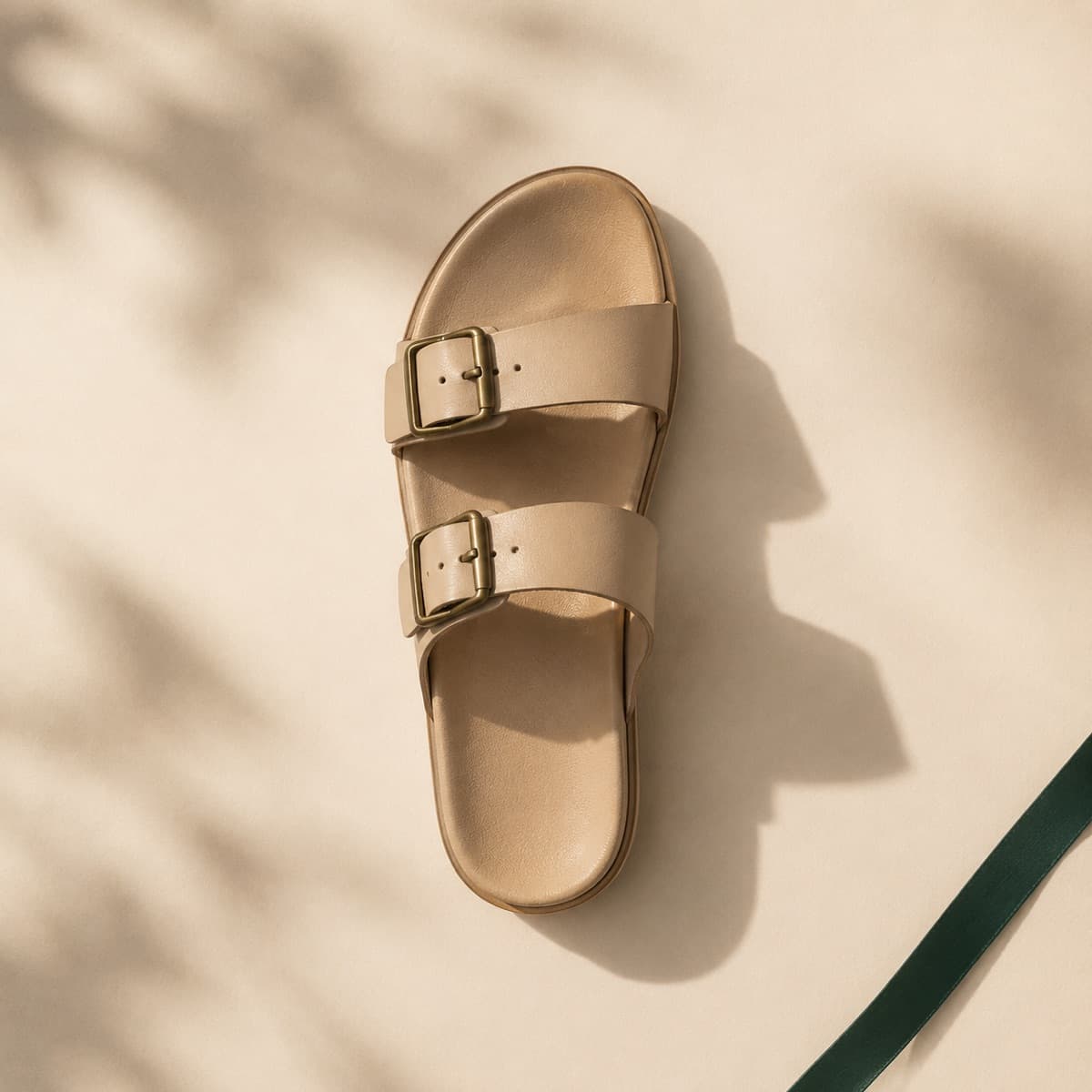 Two-Strap Flat, photographed from above against a sand-beige background