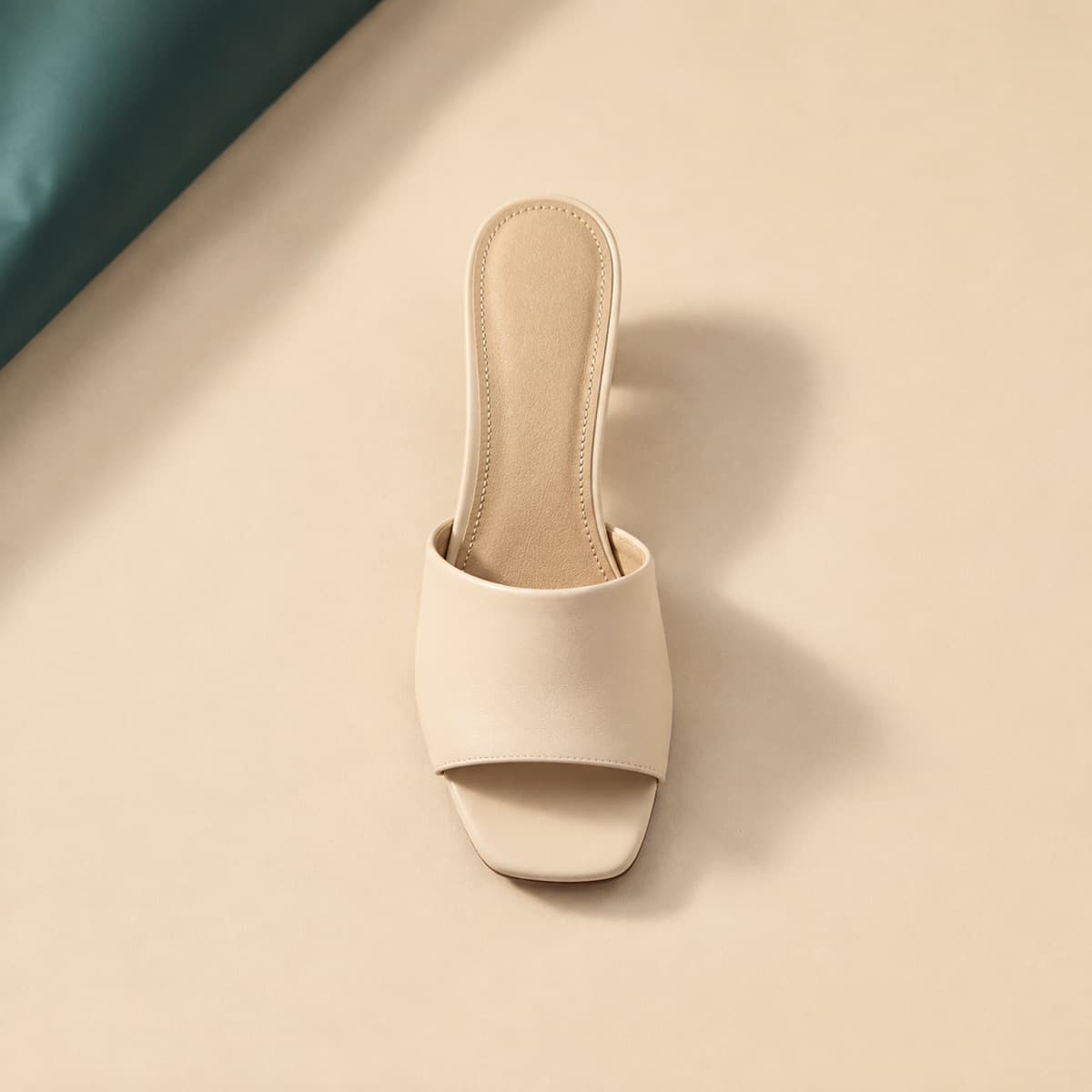 Mule Open Toe, photographed from above against a sand-beige background