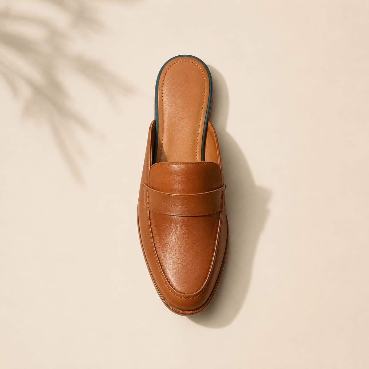 Mule Premium, photographed from above against a sand-beige background