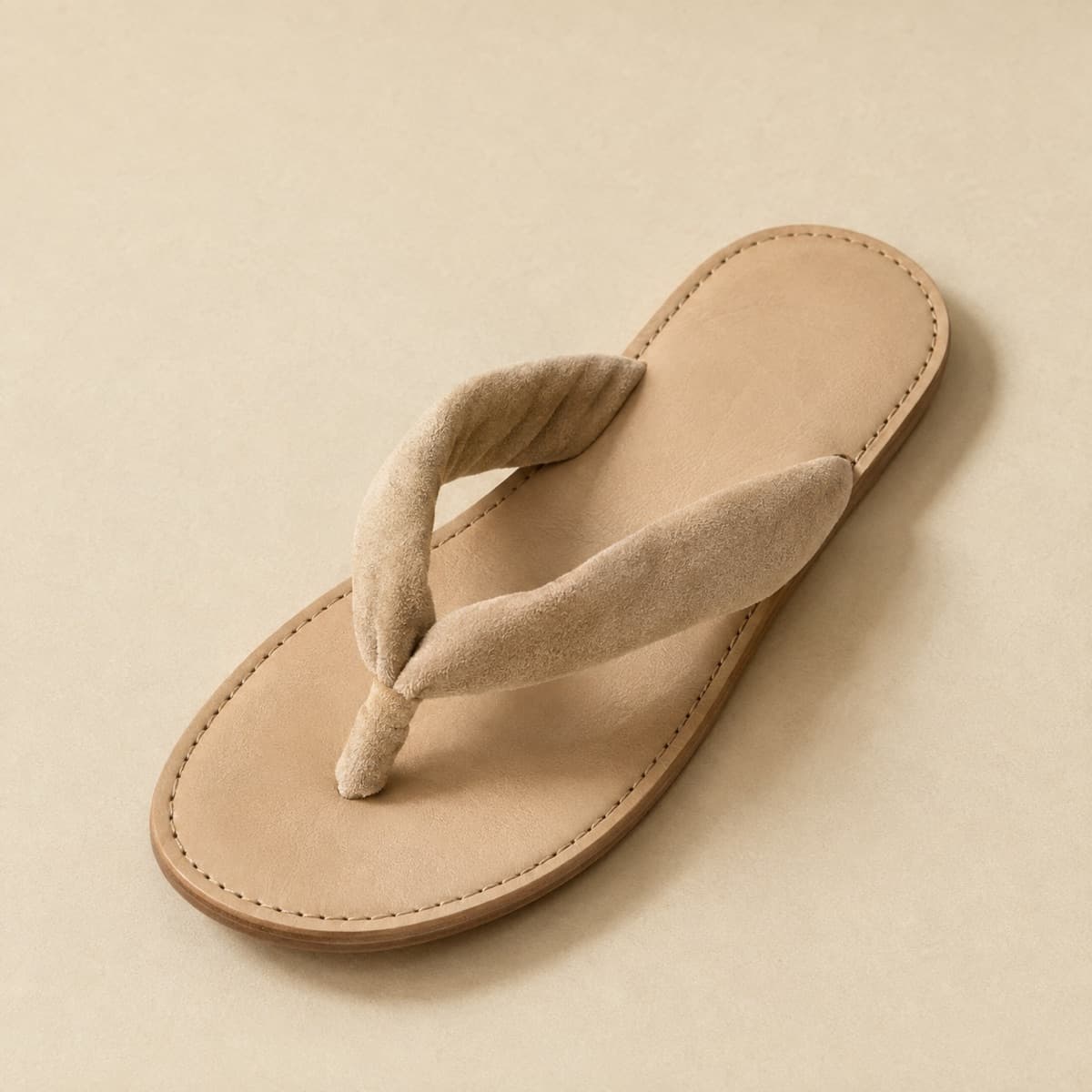 Toe-Post Padded, photographed from above against a sand-beige background