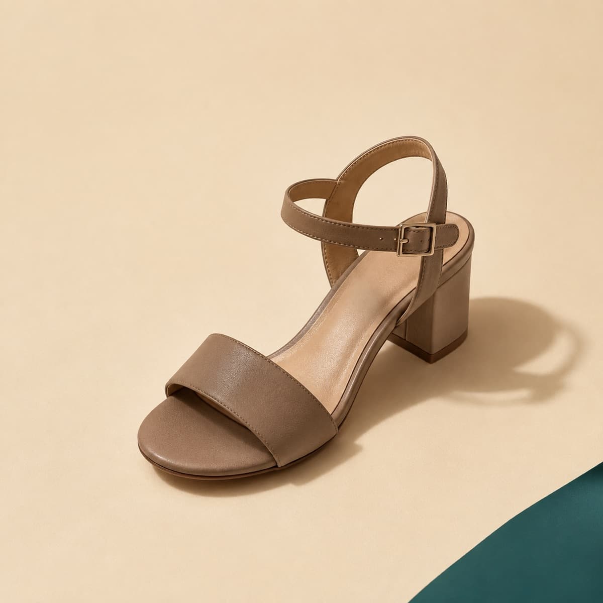 Heel Ankle Strap, photographed from above against a sand-beige background